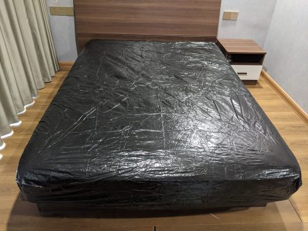 Waterproof Black PVC Fitted Sheet on bed close up texture